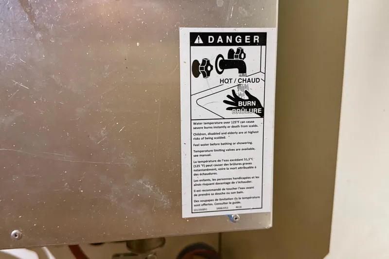 Slide: The Image of Warning label on metal surface, indicating hot water burn risk, Leopard 38, 2010 model. - 82