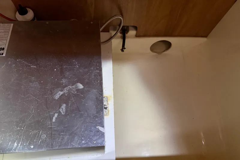 Slide: The Image of Interior of a 2010 Leopard 38 boat showing a metal panel and wooden wall. - 83