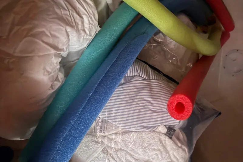 Slide: The Image of Colorful pool noodles and bedding inside a Leopard 38, 2010 model. - 84