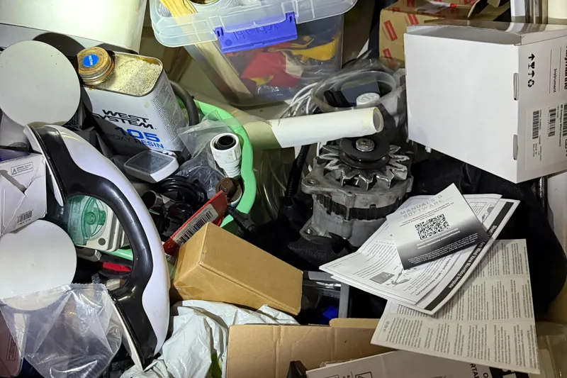 Slide: The Image of Cluttered workspace with tools, epoxy resin, and manuals, possibly for Leopard 38 maintenance. - 87