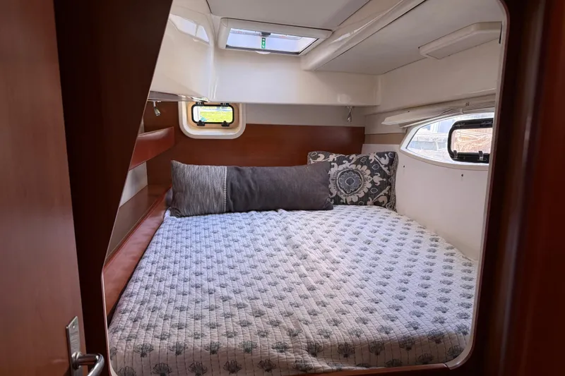 Slide: The Image of Cozy cabin interior of 2010 Leopard 38 yacht with comfortable bedding and decorative pillows. - 88