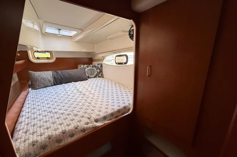 Slide: The Image of Cozy cabin interior of 2010 Leopard 38 yacht with comfortable bedding and porthole windows. - 91