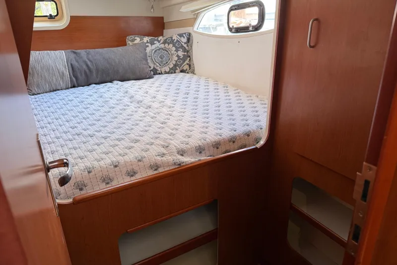 Slide: The Image of Cozy cabin interior of 2010 Leopard 38 yacht with comfortable bedding and wooden finish. - 93