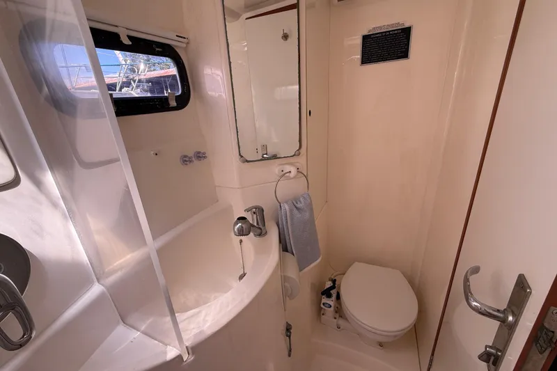 Slide: The Image of Bathroom interior of 2010 Leopard 38 yacht, featuring sink, toilet, and window. - 94