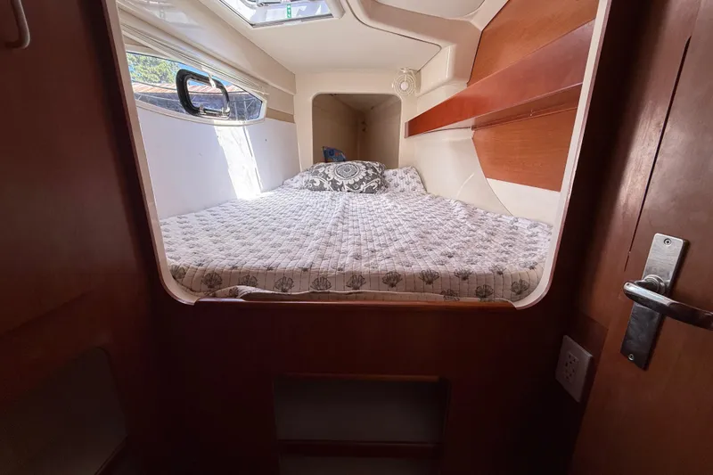Slide: The Image of Cozy cabin interior of 2010 Leopard 38 catamaran with bed and window. - 98