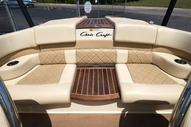 Slide: The Image of 2015 Chris-Craft Capri 21 boat interior with beige leather seating and wood accents. - 11