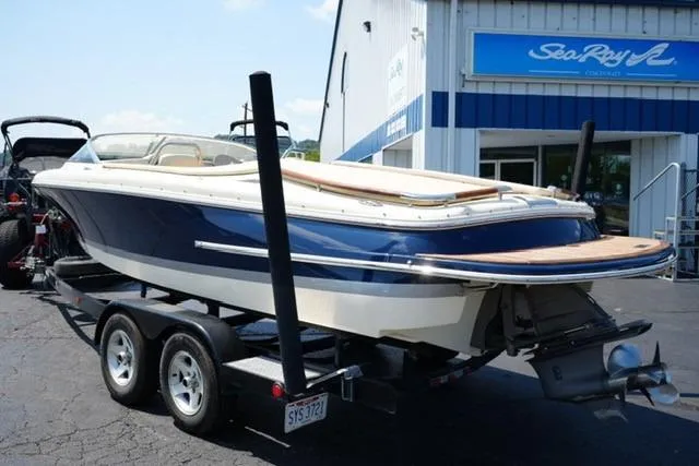 Slide: The Image of 2015 Chris-Craft Capri 21 boat on trailer outside dealership. - 5