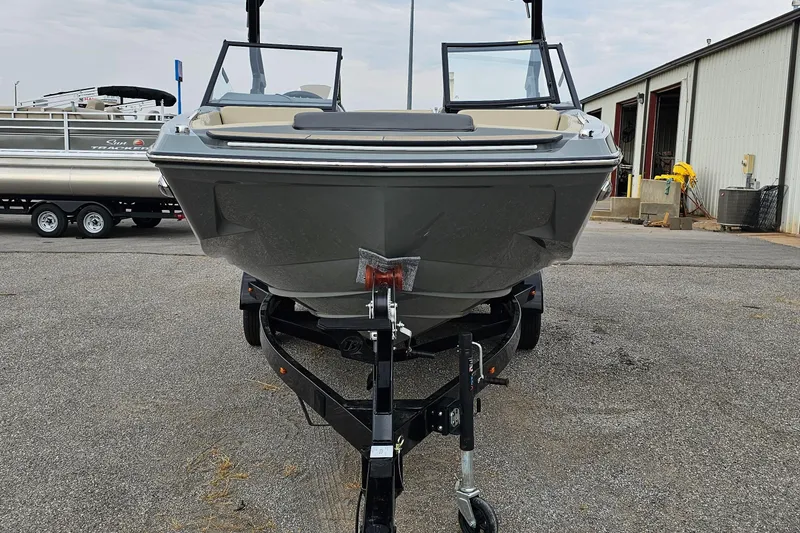Slide: The Image of 2025 Heyday H20 boat on trailer, parked outdoors near a warehouse. - 2