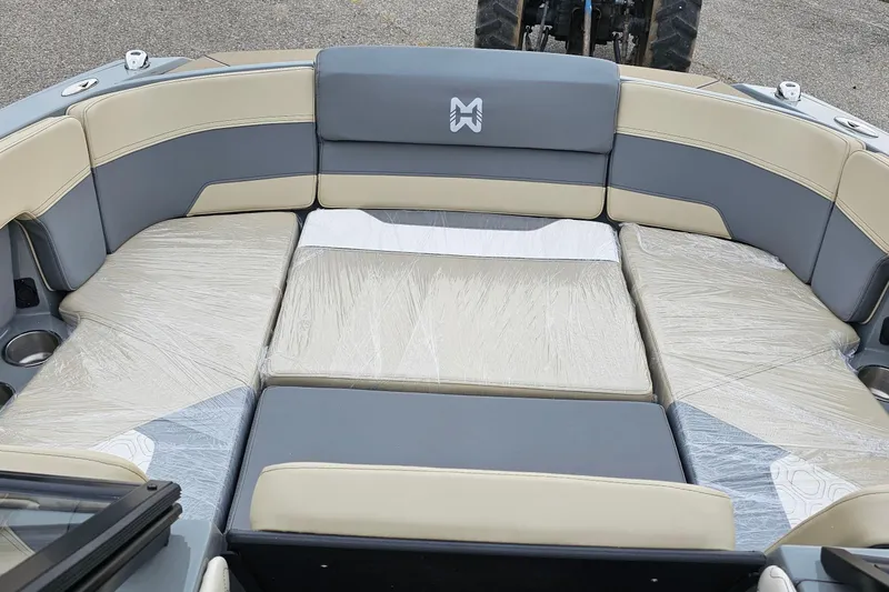 Slide: The Image of 2025 Heyday H20 boat interior with gray and beige seating, plastic-wrapped cushions. - 4