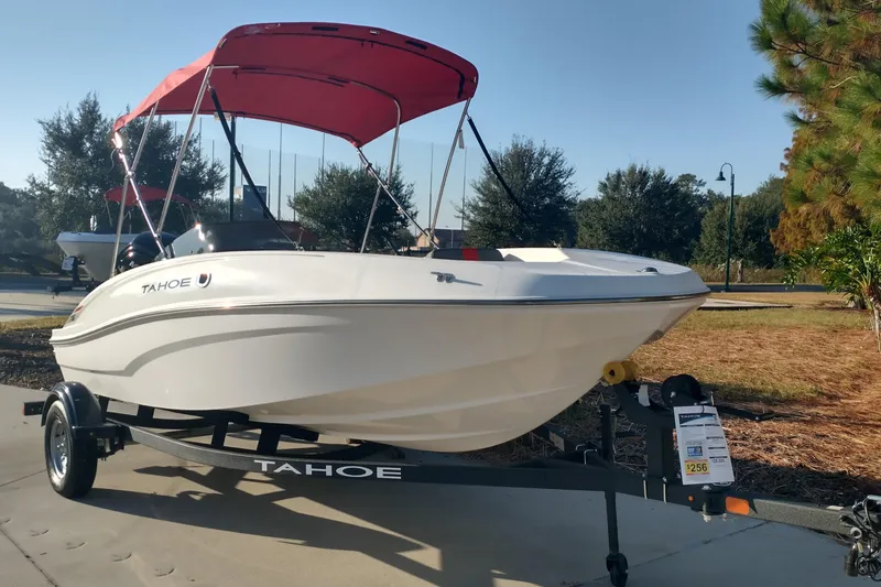 The Image of 2026 Tahoe T16 boat with red canopy on trailer, parked outdoors. - 0