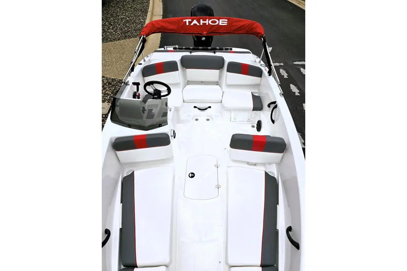 Slide: The Image of 2026 Tahoe T16 boat interior with red and gray seating, steering wheel, and windshield. - 2