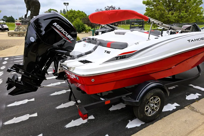 Slide: The Image of 2026 Tahoe T16 boat with Mercury engine on trailer, red and white design. - 4