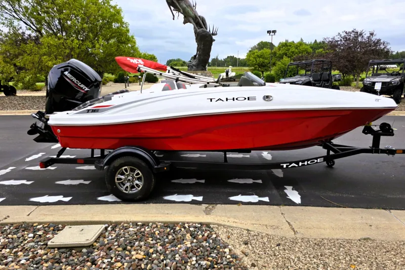 Slide: The Image of 2026 Tahoe T16 boat with red hull on trailer, parked outdoors. - 5