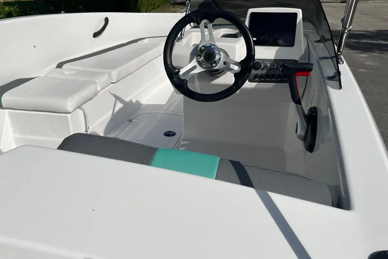 Slide: The Image of 2026 Tahoe T16 boat interior with steering wheel and seating, showcasing modern design. - 5