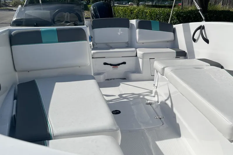 Slide: The Image of 2026 Tahoe T16 boat interior with white and teal seating, steering wheel, and open deck. - 6