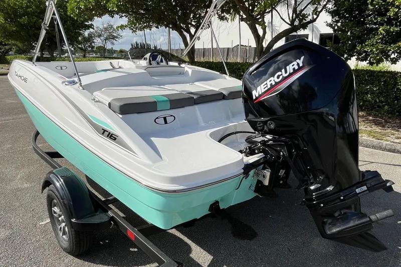 Slide: The Image of 2026 Tahoe T16 boat with Mercury engine on trailer, parked outdoors. - 7