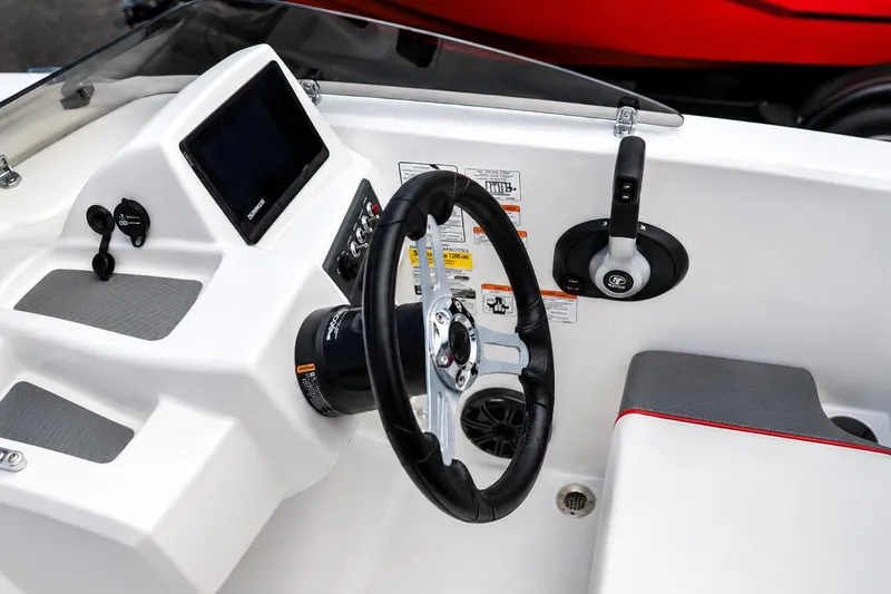 Slide: The Image of 2026 Tahoe T18 boat dashboard with steering wheel and control panel. - 5