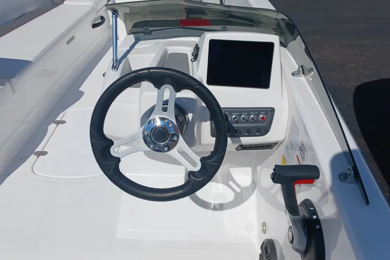 Slide: The Image of 2026 Tahoe T18 boat dashboard with steering wheel and control panel. - 6