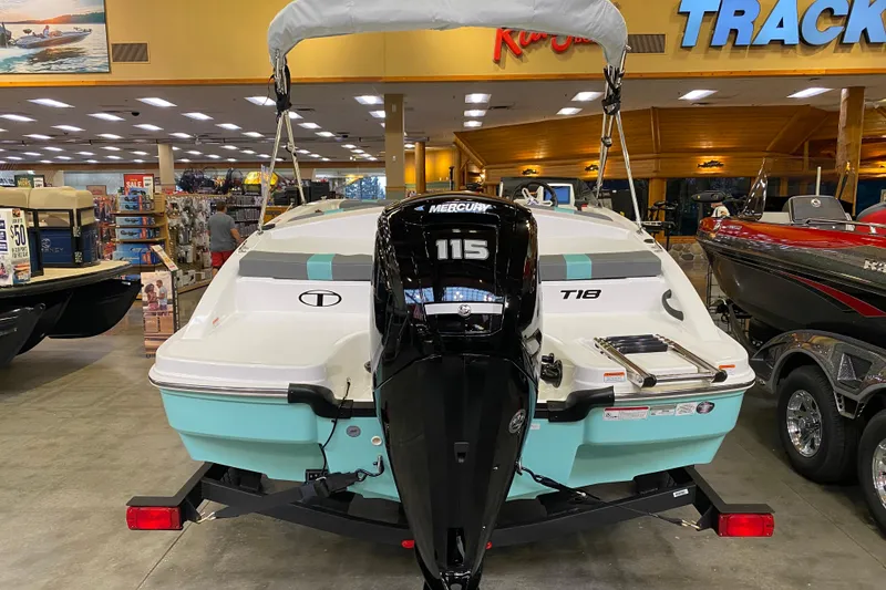 Slide: The Image of 2026 Tahoe T18 boat with Mercury 115 engine displayed indoors. - 3