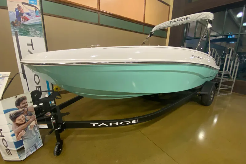 The Image of 2026 Tahoe T18 boat on display, featuring a sleek design and mint green hull. - 0