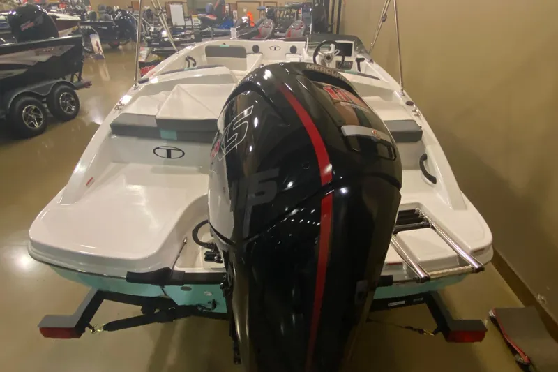 Slide: The Image of 2026 Tahoe T18 boat with powerful Mercury outboard motor displayed indoors. - 4
