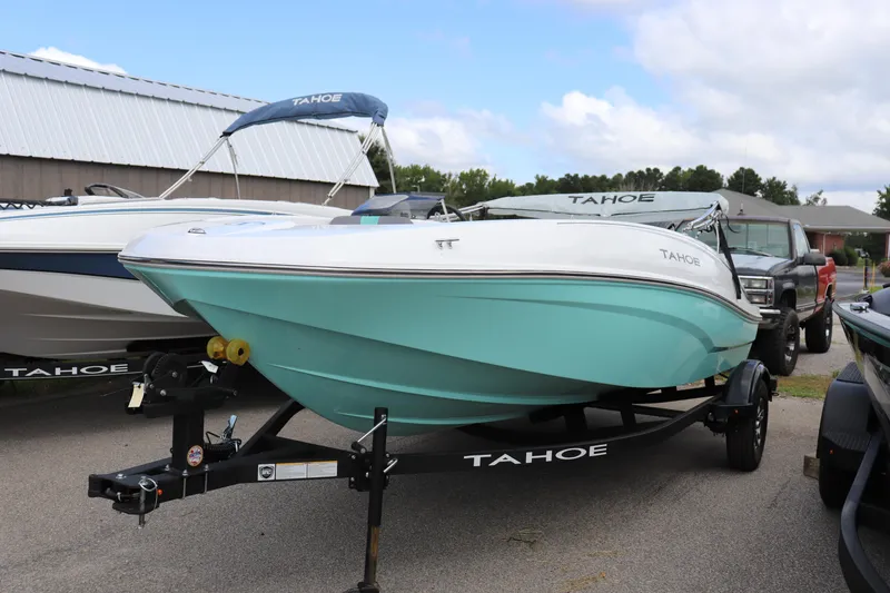 The Image of 2026 Tahoe T16 boat on trailer, turquoise hull, parked outdoors. - 0