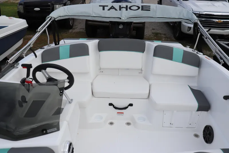 Slide: The Image of 2026 Tahoe T16 boat interior with gray and teal seating, steering wheel, and dashboard. - 4