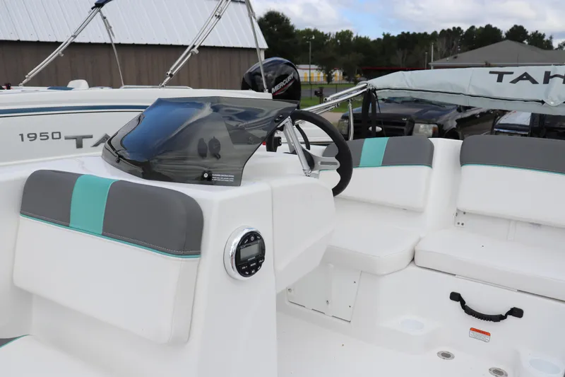 Slide: The Image of 2026 Tahoe T16 boat interior with steering wheel and seating, showcasing modern design. - 5