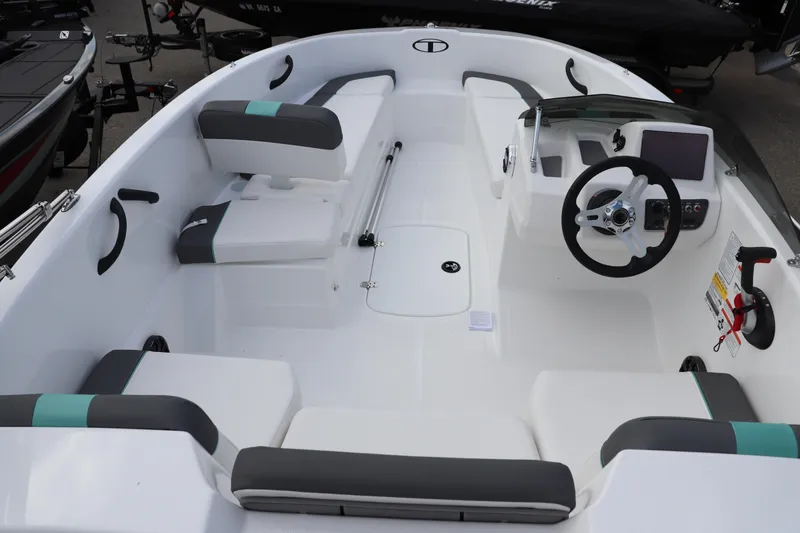 Slide: The Image of 2026 Tahoe T16 boat interior with modern seating and steering console. - 8
