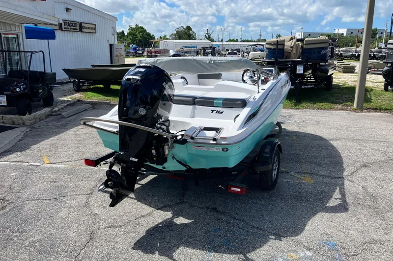 Slide: The Image of 2026 Tahoe T16 boat with outboard motor on trailer, parked outdoors. - 6
