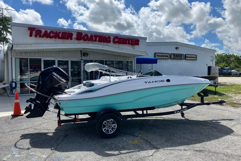 Slide: The Image of 2026 Tahoe T16 boat on trailer at Tracker Boating Center under a cloudy sky. - 68