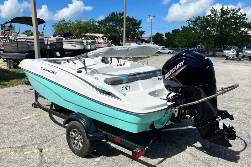 Slide: The Image of 2026 Tahoe T16 boat with Mercury engine on trailer, parked outdoors. - 69