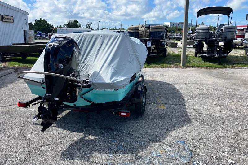 Slide: The Image of 2026 Tahoe T16 boat with cover and outboard motor in a parking lot. - 72