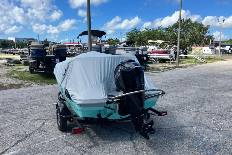 Slide: The Image of Covered 2026 Tahoe T16 boat on trailer in outdoor lot, surrounded by other boats. - 8