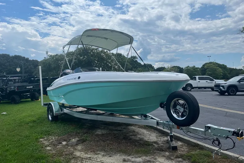 Slide: The Image of 2026 Tahoe T18 boat on trailer, parked outdoors under a cloudy sky. - 3