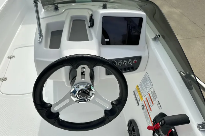 Slide: The Image of 2026 Tahoe T16 boat dashboard with steering wheel and control panel. - 4
