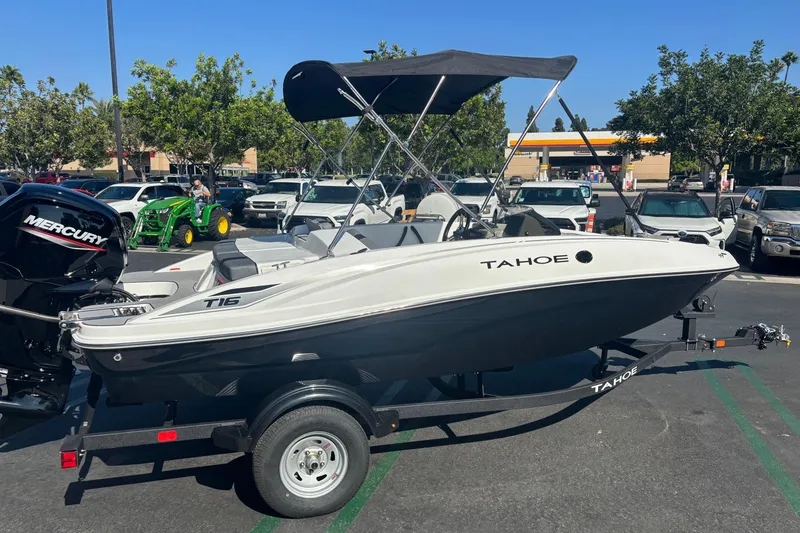 Slide: The Image of 2026 Tahoe T16 boat with Mercury engine on trailer in parking lot. - 0