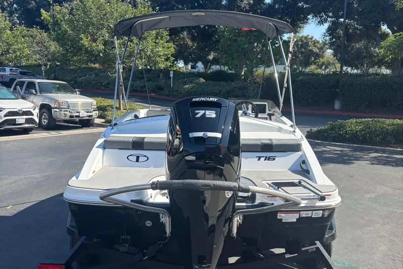 Slide: The Image of 2026 Tahoe T16 boat with Mercury 75 engine in a parking lot. - 2