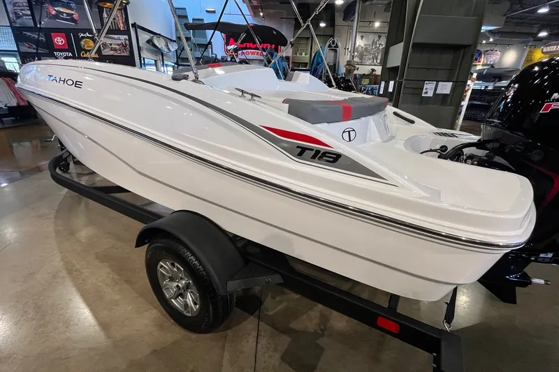 Slide: The Image of 2026 Tahoe T18 boat on display in showroom, featuring sleek white design and modern detailing. - 6
