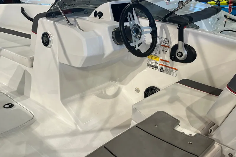 Slide: The Image of 2026 Tahoe T18 boat interior with steering wheel and seating area. - 10