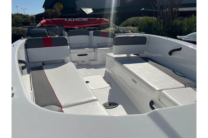 Slide: The Image of 2026 Tahoe T18 boat interior with white and gray seating, red accents, and open deck layout. - 64