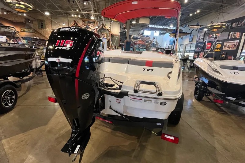 Slide: The Image of 2026 Tahoe T18 boat with Mercury 115 Pro motor displayed indoors. - 7