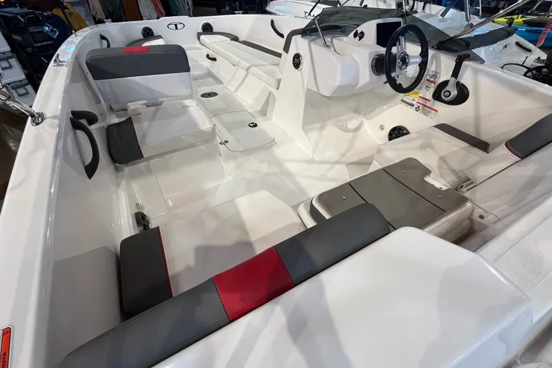 Slide: The Image of 2026 Tahoe T18 boat interior with modern seating and steering wheel. - 9