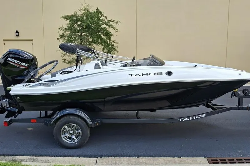 The Image of 2026 Tahoe T16 boat on trailer, featuring sleek black and white design. - 0
