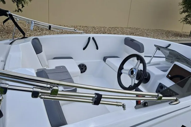 Slide: The Image of 2026 Tahoe T16 boat interior with steering wheel, seating, and modern controls. - 2