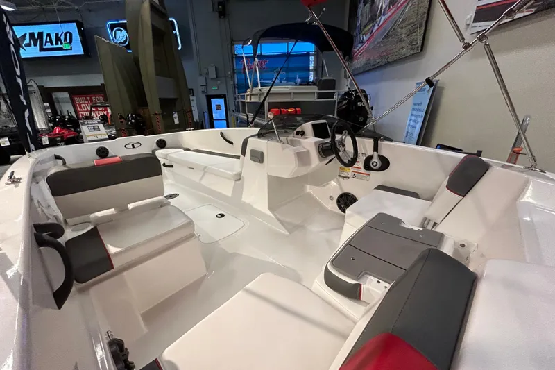 Slide: The Image of 2026 Tahoe T18 boat interior with modern seating and steering wheel in showroom. - 3