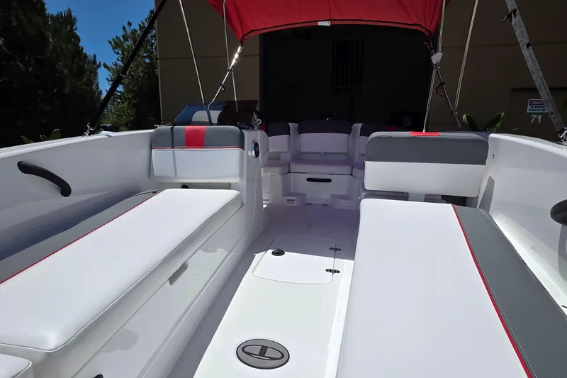Slide: The Image of 2026 Tahoe T18 boat interior with white and gray seating, red accents, and canopy. - 4