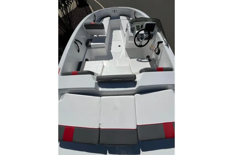 Slide: The Image of 2026 Tahoe T16 boat interior with modern seating and steering console. - 2