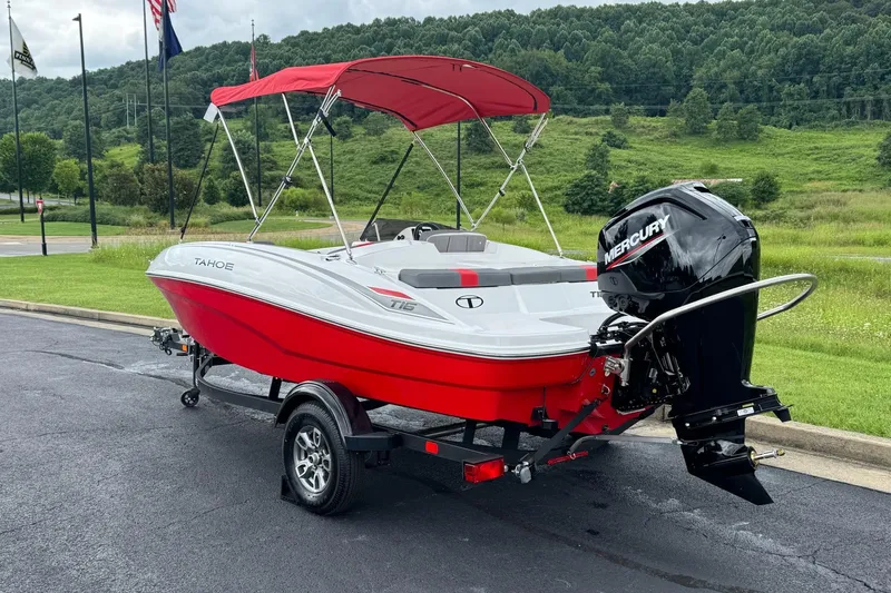Slide: The Image of 2026 Tahoe T16 boat with red canopy and Mercury engine on trailer. - 2