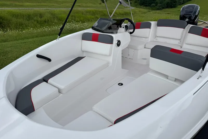 Slide: The Image of 2026 Tahoe T16 boat interior with white and gray seating, red accents, and steering console. - 4